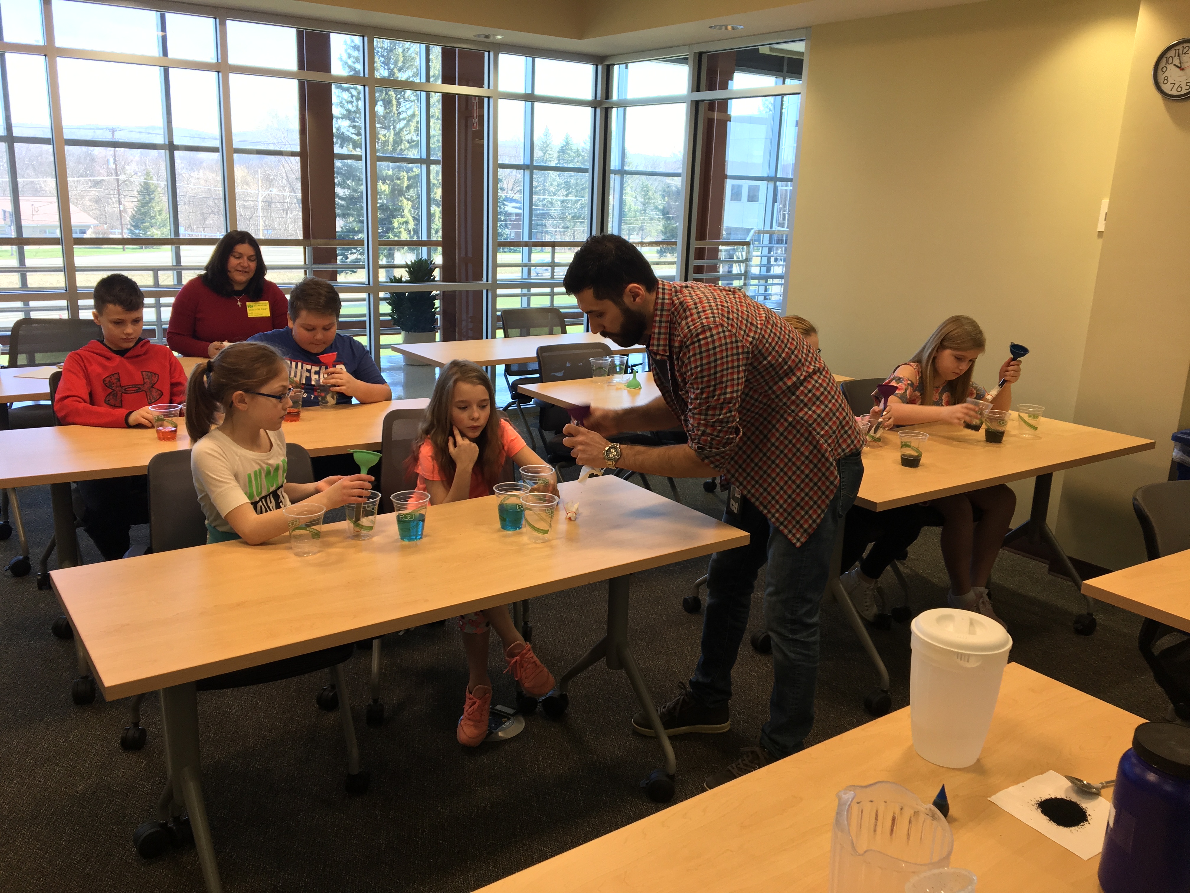 Morteza helping students with adsorption outreach activity